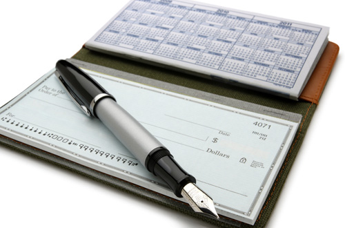 a checkbook with a pen on top